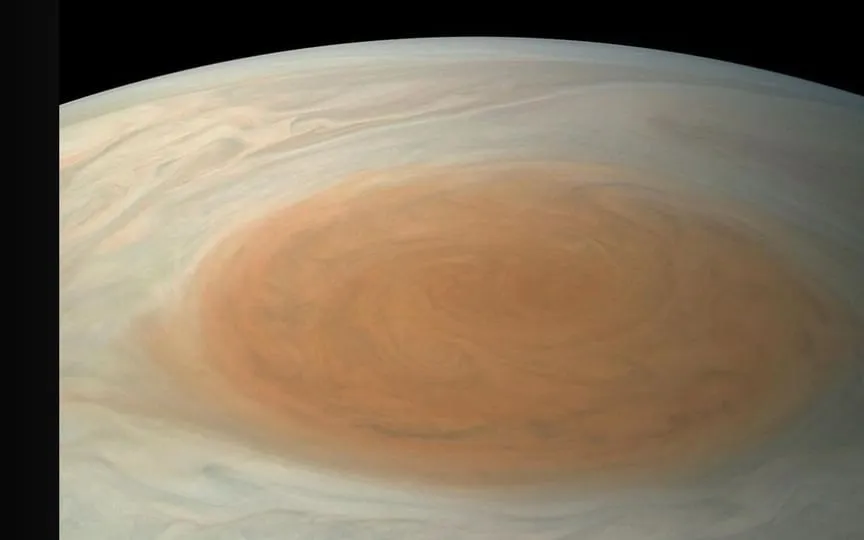 NASA's Juno spacecraft unveils Jupiter's Great Red Spot, a colossal storm twice Earth's size, captivates space enthusiasts. ( NASA/JPL-Caltech/SwRI/MSSS/Bjorn Jonsson⁣)