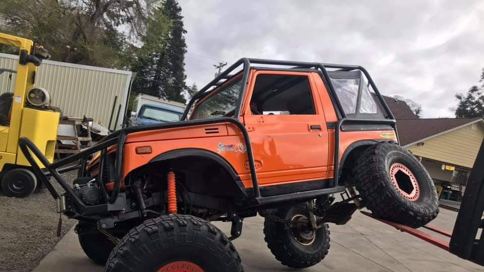 orange suzuki samurai lifted