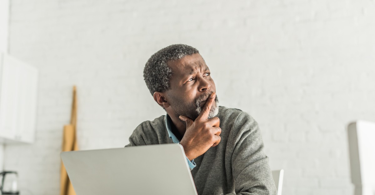 thoughtful senior man Thoughtful senior man looking away from his computer