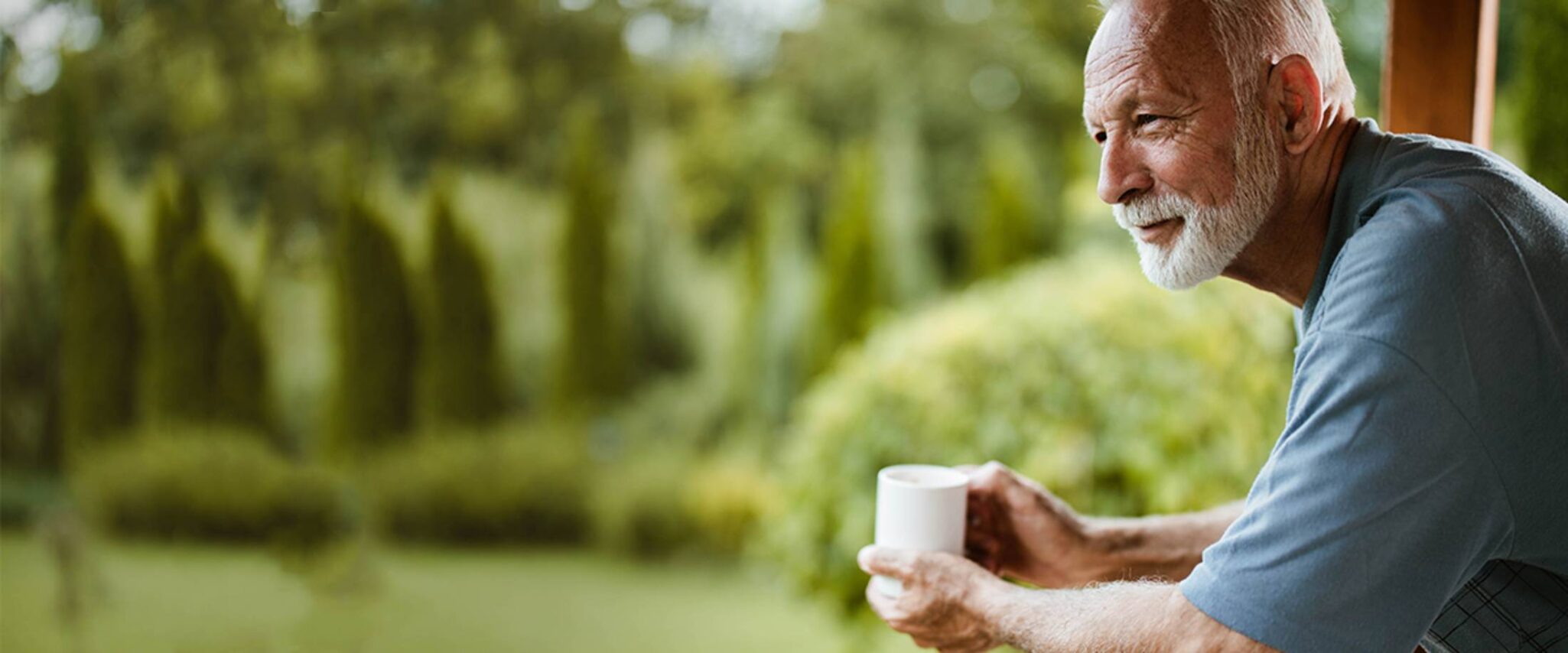 dcac33e1-rgoaks_august_blog_1a senior man practices mindfulness and meditation on porch with coffee