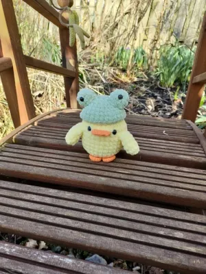 Amigurumi duck with bunny and frog hat