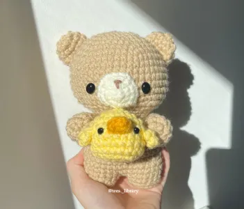 Bear Holding Chick