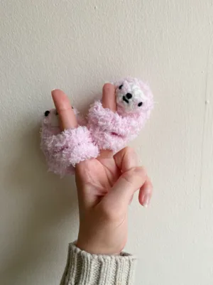 Fluffy finger hugging sloth