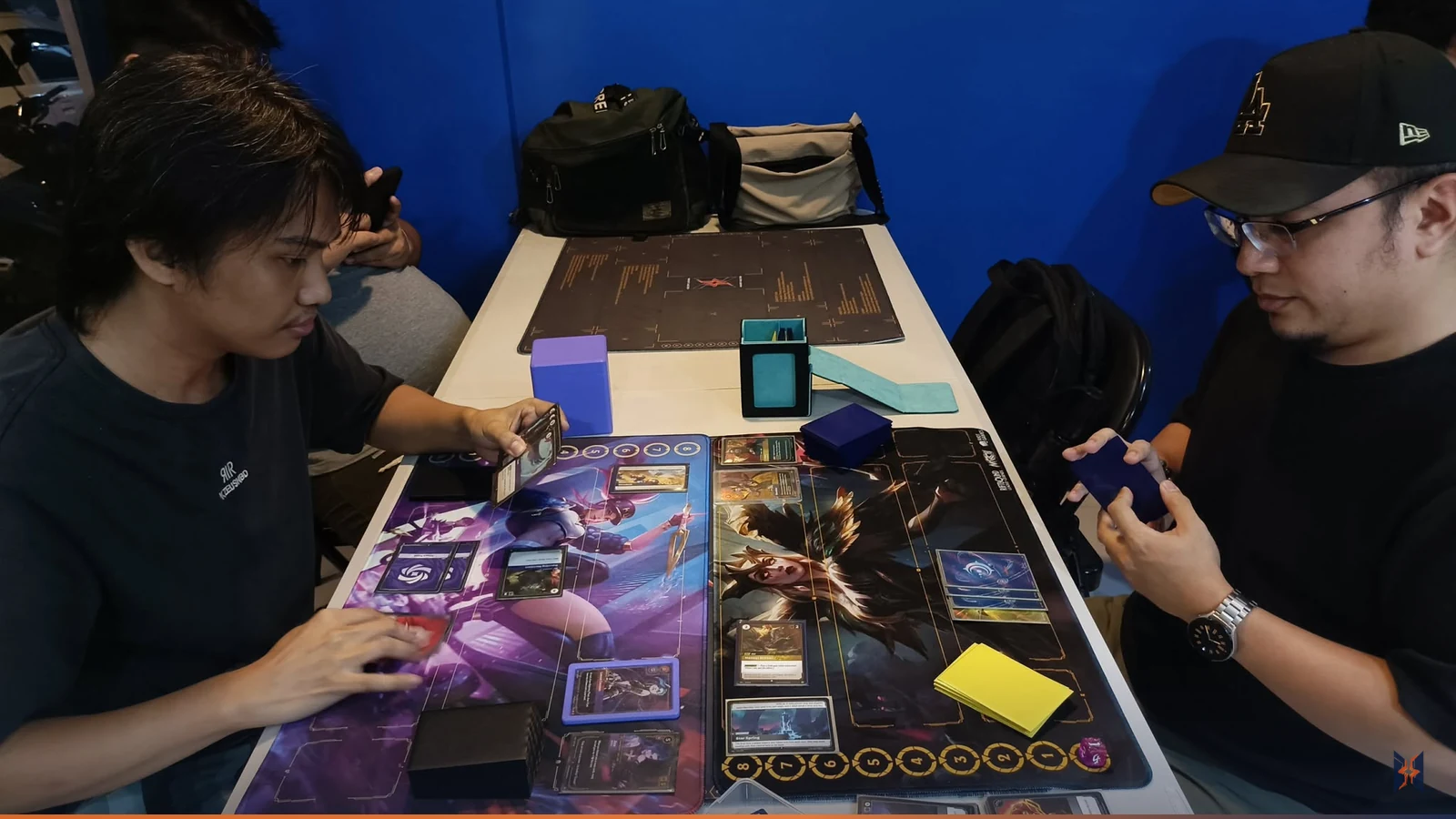 Two players in a head-to-head Riftbound match during League Session 2