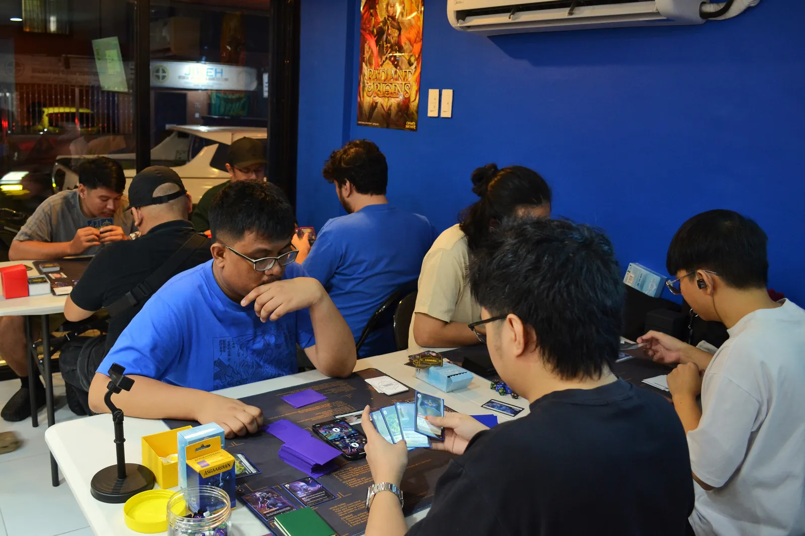 Players building and playing Radiance Sealed decks at the Friday Pre-Rift at Rift Vault