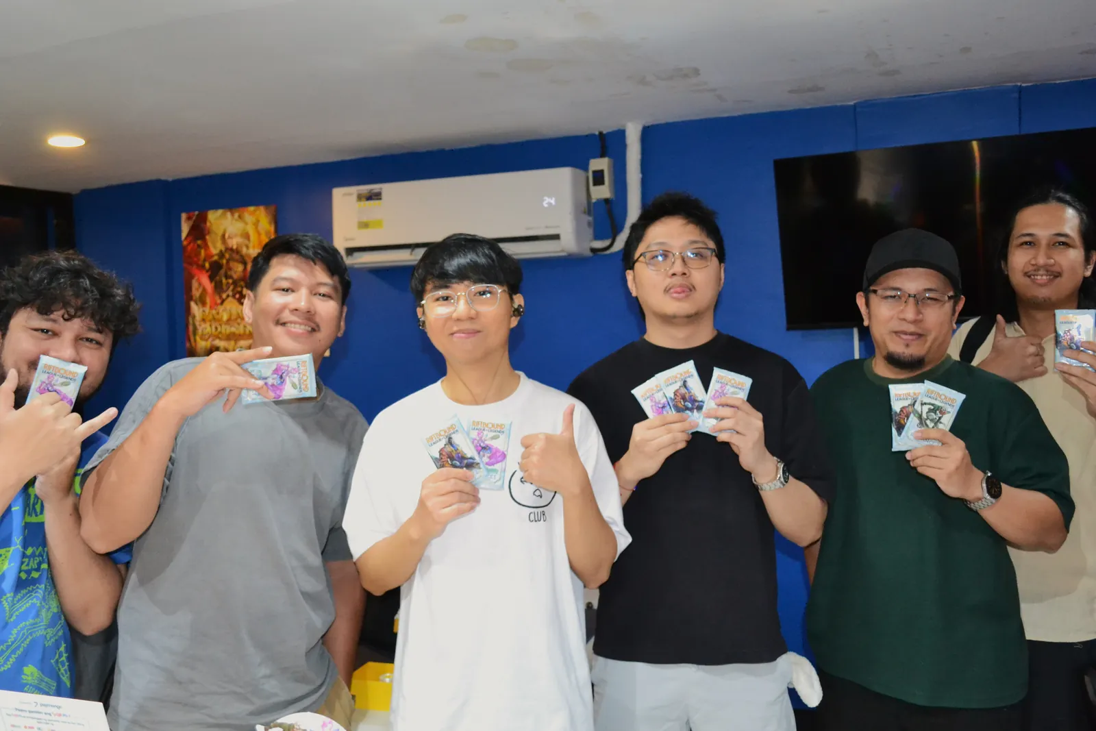 Friday Radiance Pre-Rift players holding up their Radiance packs at Rift Vault