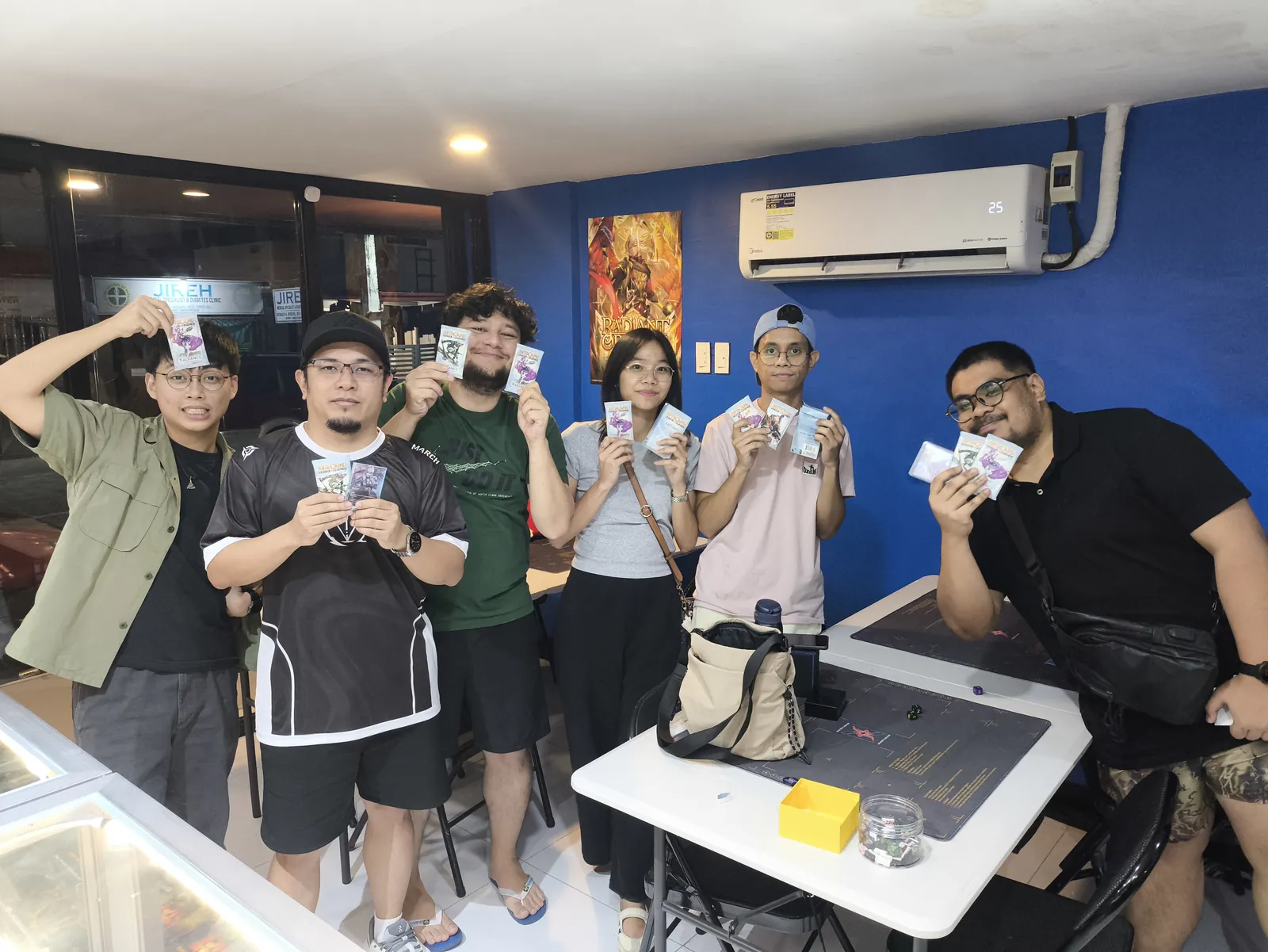 Saturday Radiance Pre-Rift players holding up their Radiance packs at Rift Vault