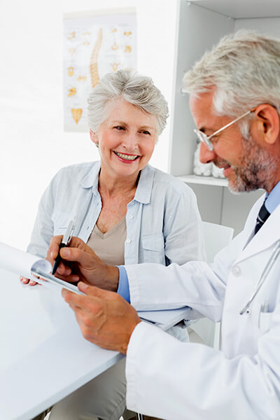 woman patient meeting with physician taking notes