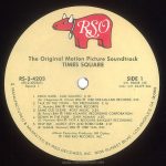 Label side 1 of 4 of the "Times Square" soundtrack album. Text: RSO The Original Motion Picture Soundtrack TIMES SQUARE RS-2-4203 (RS-2-4203AS) Record 1 SIDE 1 Intl. #2658 145 Indv. Intl. #2479 264 1. ROCK HARD - SUZI QUATRO 3:18 (M. Chapman-N. Chinn) BMI ℗ 1980 DREAMLAND RECORDS, INC. 2. TALK OF THE TOWN - THE PRETENDERS 3:16 (C. Hynde) BMI ℗ 1980 REAL RECORDS 3. SAME OLD SCENE - ROXY MUSIC 3:54 (B. Ferry) BMI ℗ 1980 ATLANTIC RECORDING CORPORATION 4. DOWN IN THE PARK - GARY NUMAN 4:20 (G. Numan) BMI ℗ 1979 A BEGGARS BANQUET RECORDING 5. HELP ME! - MARCY LEVY AND ROBIN GIBB 3:37 (R. Gibb-B. Weaver) BMI ℗ 1980 YAM, INC. Album Executive Producer: Bill Oakes ℗ 1980 RSO RECORDS, INC. 49 MANUFACTURED & MARKETED BY RSO RECORDS INC. 8335 SUSNSET BLVD., LOS ANGELES, CA. 90069