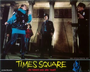 The cops confront Nicky atop the Times Square Theatre marquee. Text: schröder-filmverleih TIMES SQUARE ...ihr könnt uns alle 'mal!! FSK FREIGEGEBEN [2nd set]