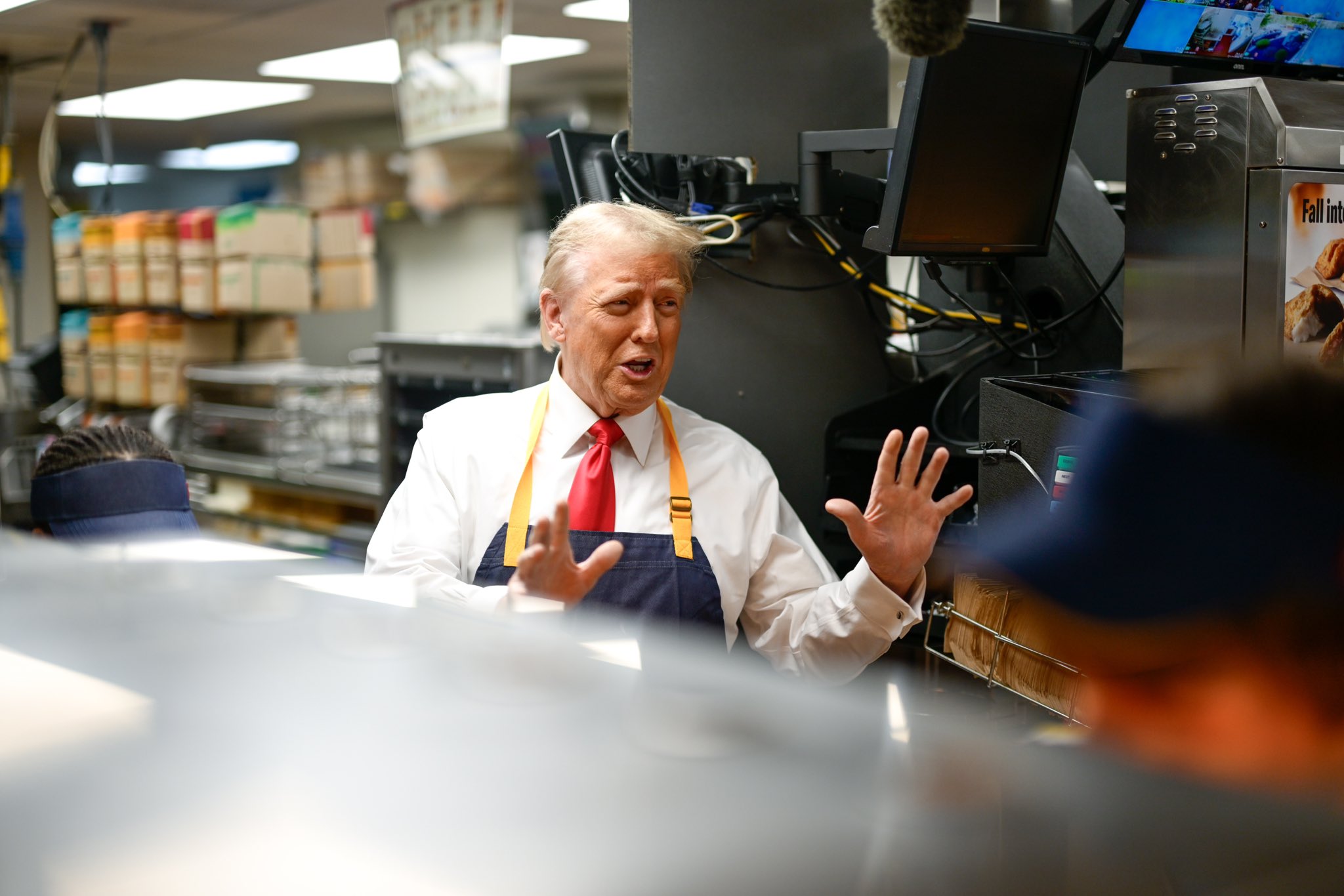 MxM News Trump jumps behind McDonald's counter to grill Kamala Harris