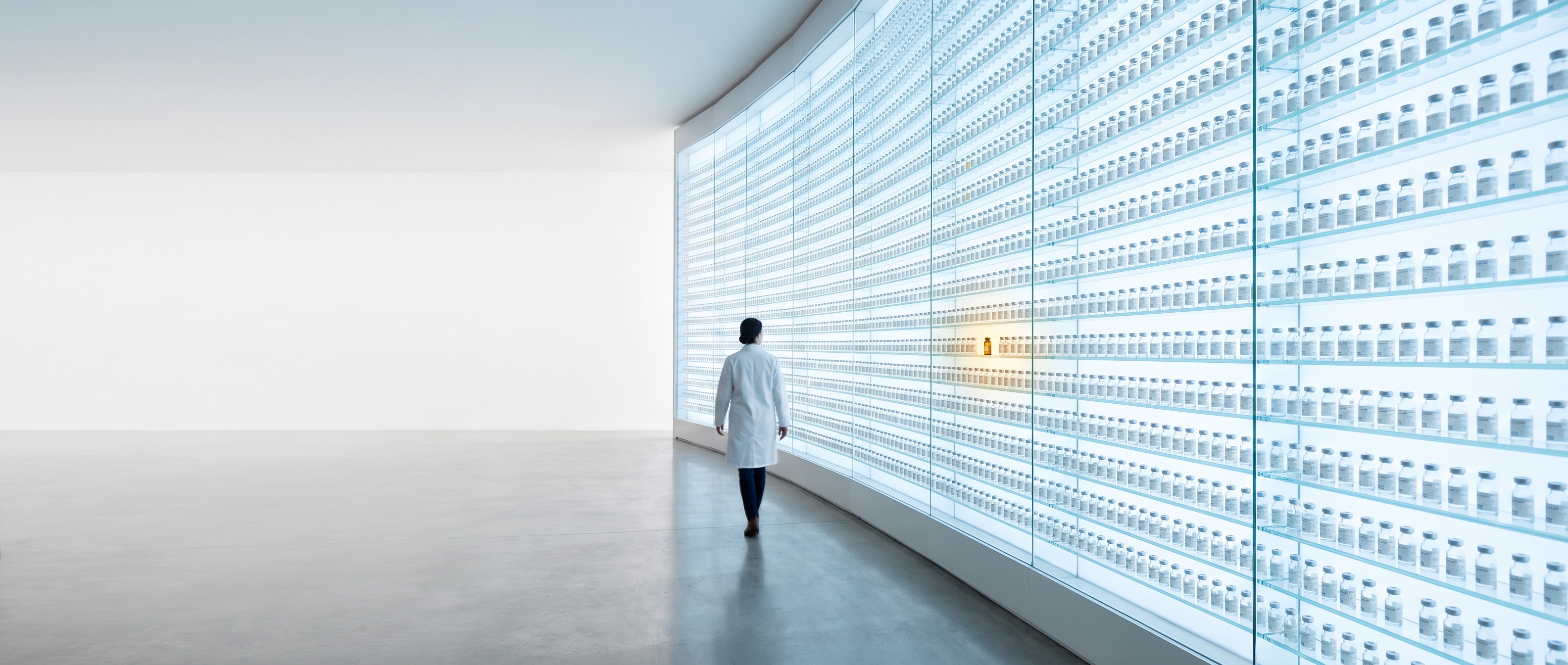 Curved luminous wall of thousands of backlit clear vials, pharmacist walking toward one warm lit vial