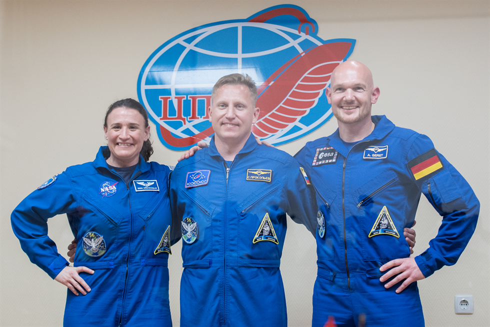 Expedition 56 flight engineer Serena Auñón-Chancellor of NASA, left, Soyuz Commander Sergey Prokopyev of Roscosmos, center, and flight engineer Alexander Gerst of ESA (European Space Agency) pose for a picture following a press conference on June 5 at the Cosmonaut Hotel in Baikonur, Kazakhstan. Image Credit: NASA/Joel Kowsky