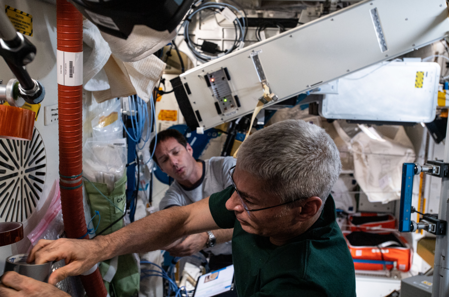 NASA astronaut Mark Vande Hei and ESA (European Space Agency) astronaut Thomas Pesquet are photographed working with the Brine Processor Assembly filter build. Credits: NASA