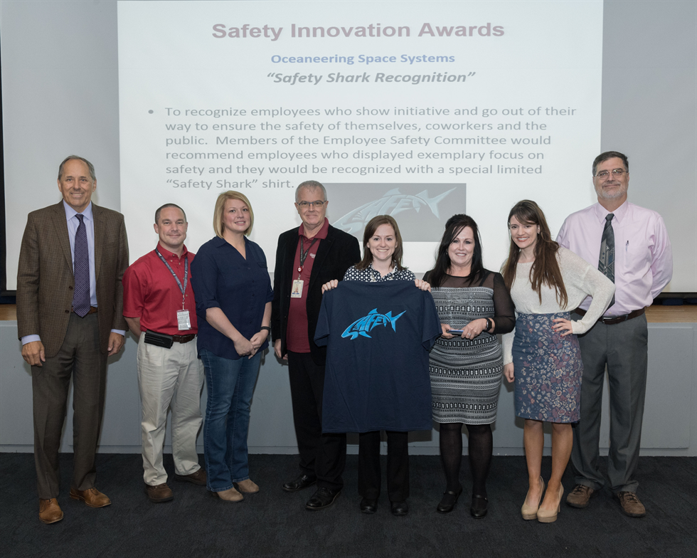 Oceaneering Space Systems received the Innovation Award—the highest honor—and also a special “Safety Shark” shirt to go along with it. Image Credit: NASA/Robert Markowitz