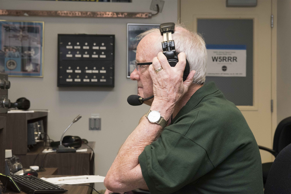 Milt Heflin using the ham radio to communicate with others across the country. 