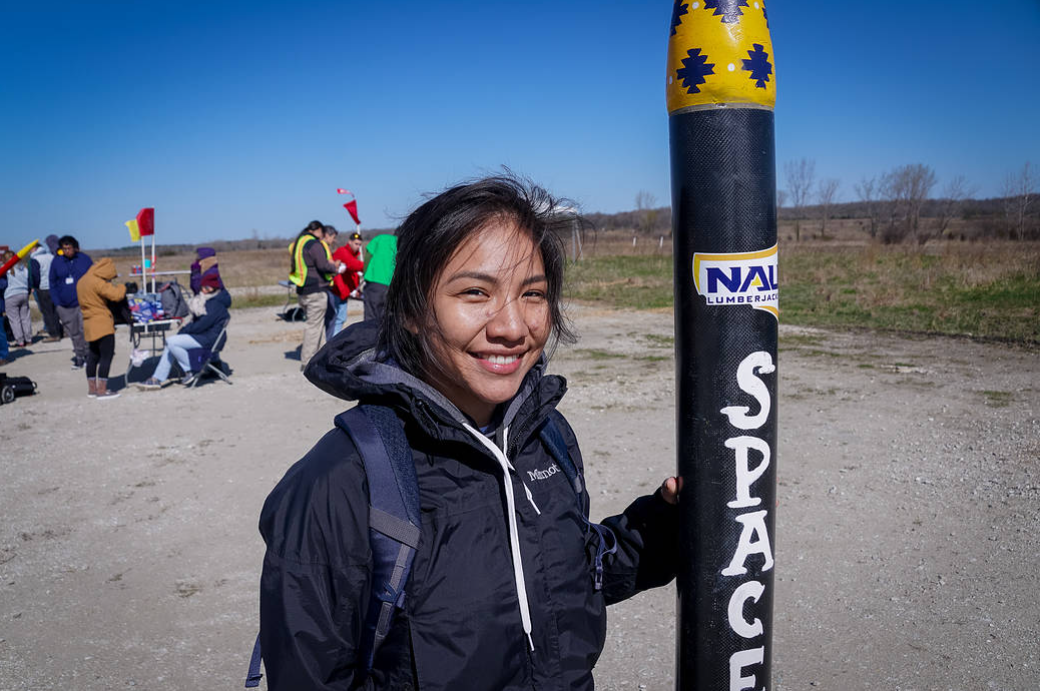 Stephanie Yazzie, Northern Arizona University student and NAU Space Jacks team member, poses with her team’s rocket in this photo from the 2019 NASA First Nations Launch competition. Credits: Carthage College/Christine Bolz