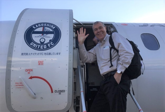 Hartman boarding a plane to the HTV-6 launch in Tanegashima, Japan.