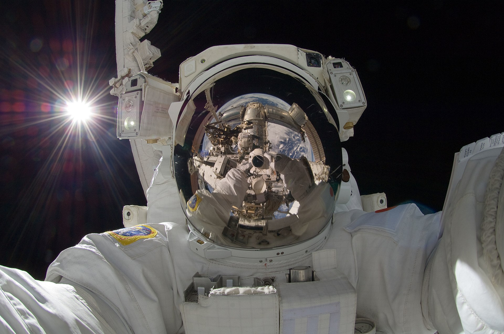 Hoshide taking a space selfie during a spacewalk on September 5, 2012, with the Sun behind him. 