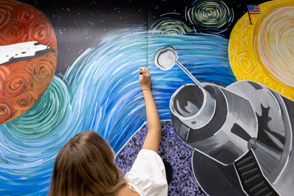 Students made final touches to their art mural. Credit: NASA/Josh Valcarcel