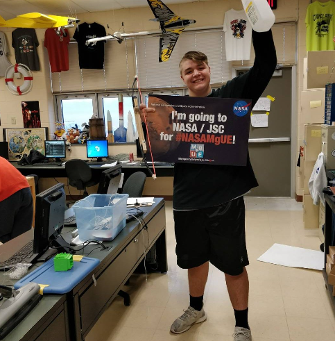 A student from team Rock Rovers in Southampton, Pennsylvania, proudly shows off their #NASAMgUE sign after their team’s SLED was completed and shipped to NASA.