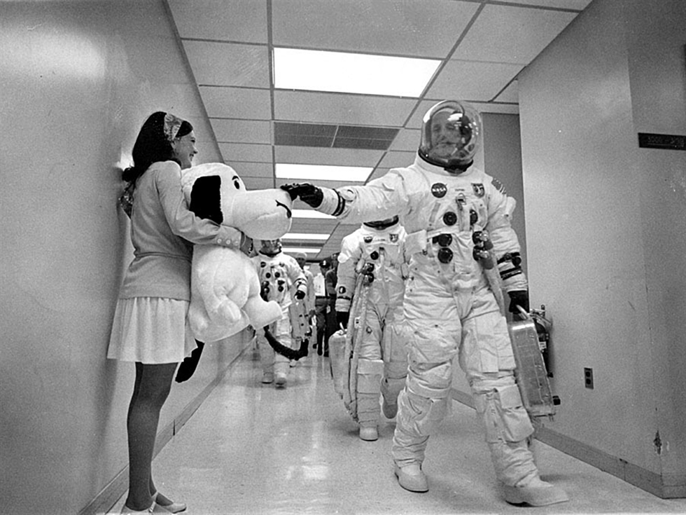 Headed for the launch pad, Apollo 10 Commander Tom Stafford pats the nose of a stuffed Snoopy held by Jamye Flowers (Coplin), astronaut Gordon Cooper’s secretary. Image Credit: NASA