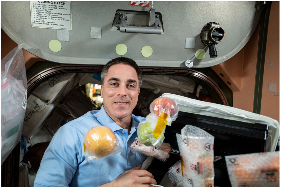 Fresh whole fruits and other food items float around NASA astronaut Chris Cassidy who, on Expedition 63, participated in a study to gauge how an enhanced diet affected his physiology. Credits: NASA