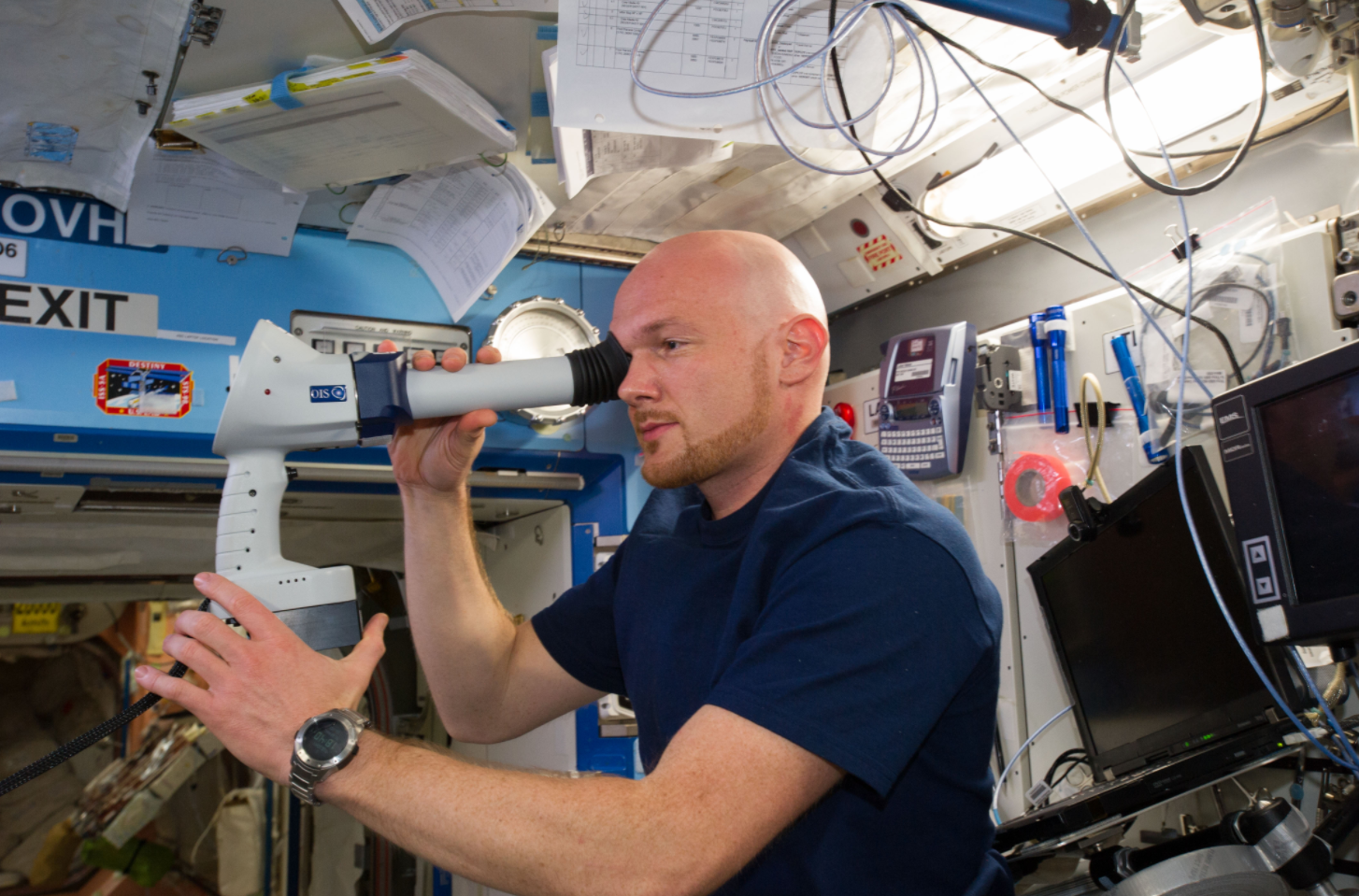 Flight Engineer Alexander Gerst uses the fundoscope during an ocular health exam aboard the orbiting laboratory. Credits: NASA