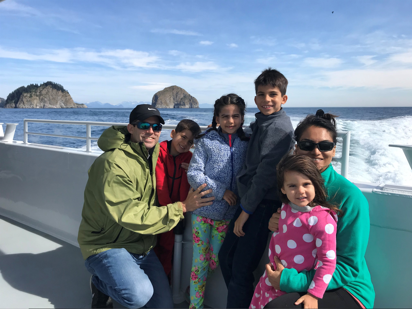 Sabrina Gilmore, shown in green on the far right, with her husband and four children during a windy family vacation off the West Coast. Image courtesy of Sabrina Gilmore