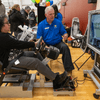 Groups of people enjoy a variety of indoor and outdoor exhibits and displays during a safety and health fair.