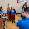 Groups of people enjoy a variety of indoor and outdoor exhibits and displays during a safety and health fair.