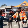 Groups of people enjoy a variety of indoor and outdoor exhibits and displays during a safety and health fair.