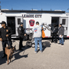 Groups of people enjoy a variety of indoor and outdoor exhibits and displays during a safety and health fair.