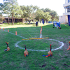 A group of people gathered outside on the lawn during a turkey launch. 