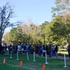 A group of people gathered outside on the lawn during a turkey launch. 