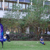 A group of people gathered outside on the lawn during a turkey launch. 