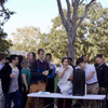 A group of people gathered outside on the lawn during a turkey launch. 