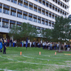 A group of people gathered outside on the lawn during a turkey launch. 