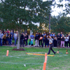 A group of people gathered outside on the lawn during a turkey launch. 