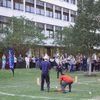 A group of people gathered outside on the lawn during a turkey launch. 