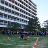 A group of people gathered outside on the lawn during a turkey launch. 