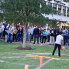 A group of people gathered outside on the lawn during a turkey launch. 