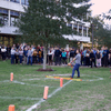 A group of people gathered outside on the lawn during a turkey launch. 