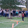 A group of people gathered outside on the lawn during a turkey launch. 