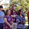 A group of people gathered outside on the lawn during a turkey launch. 