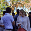 A group of people gathered outside on the lawn during a turkey launch. 