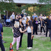 A group of people gathered outside on the lawn during a turkey launch. 