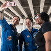 Photos of children and their families enjoying a holiday event that featured NASA astronauts and activities.