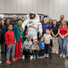 Photos of children and their families enjoying a holiday event that featured NASA astronauts and activities.