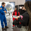 Photos of children and their families enjoying a holiday event that featured NASA astronauts and activities.